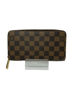Brown checkered wallet on a white background