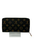 Black wallet with gold monogram pattern on a white background