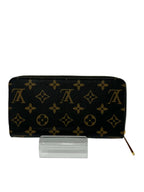 Black wallet with gold monogram pattern on a white background