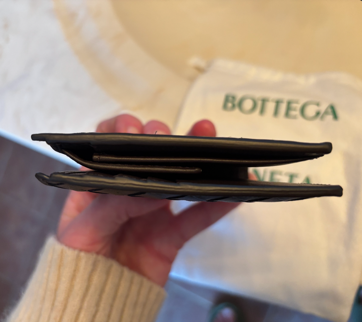 Black wallet held by side