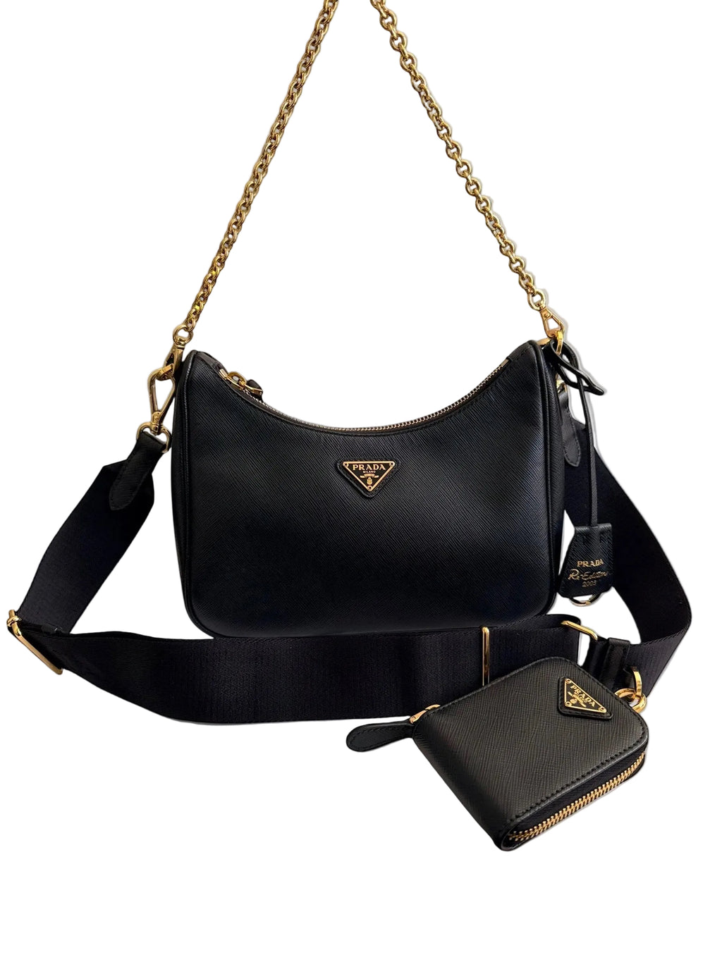 Black Prada handbag with gold chain and matching wallet on a white background

