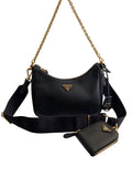 Black Prada handbag with gold chain and matching wallet on a white background
