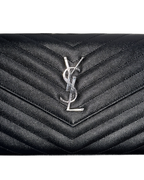 Black quilted leather handbag with a brand logo on a white background