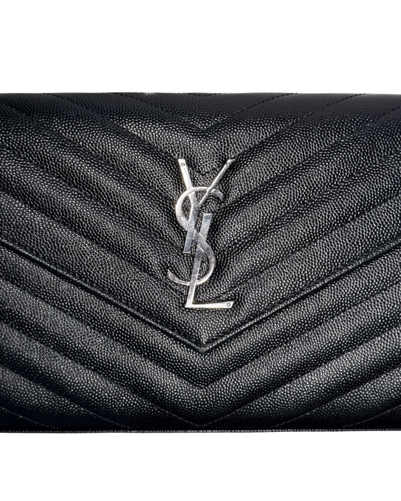 Black quilted leather handbag with a brand logo on a white background